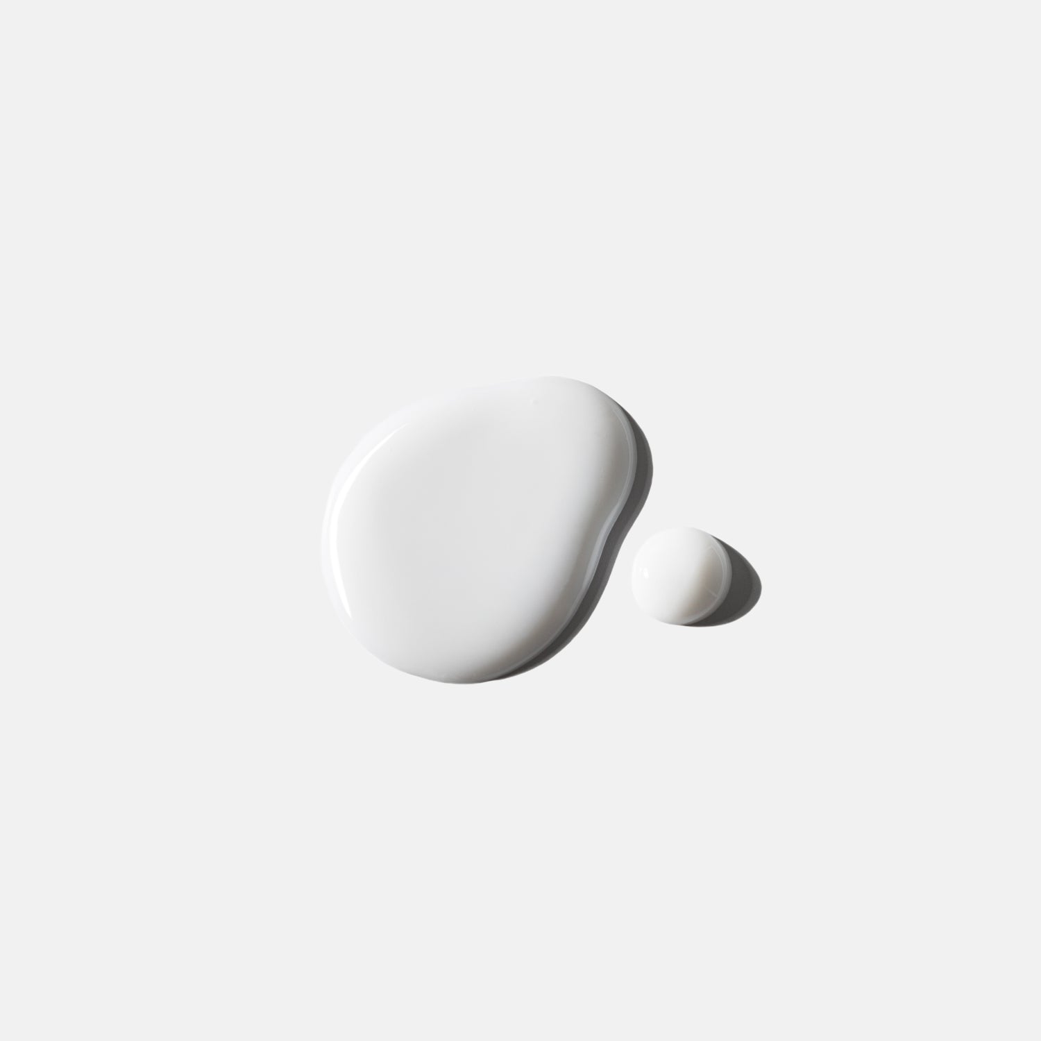 Two white ceramic stones on a light gray background