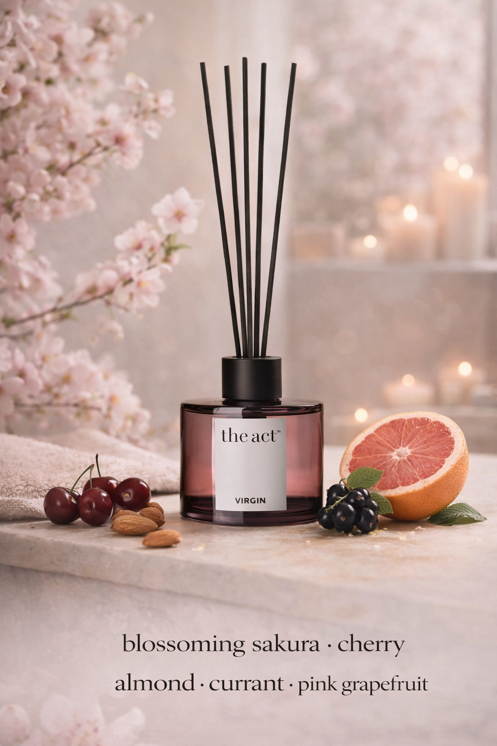 Diffuser with cherry, almond, currant, and pink grapefruit scents on a decorative surface with flowers and fruit.