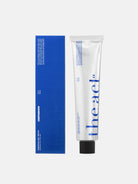 White tube with blue label and black cap next to a blue box on a white background